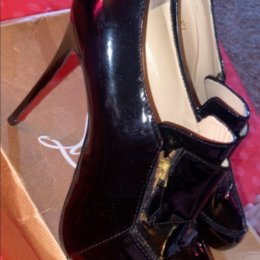 Christian Louboutin black patten leather shoes.
